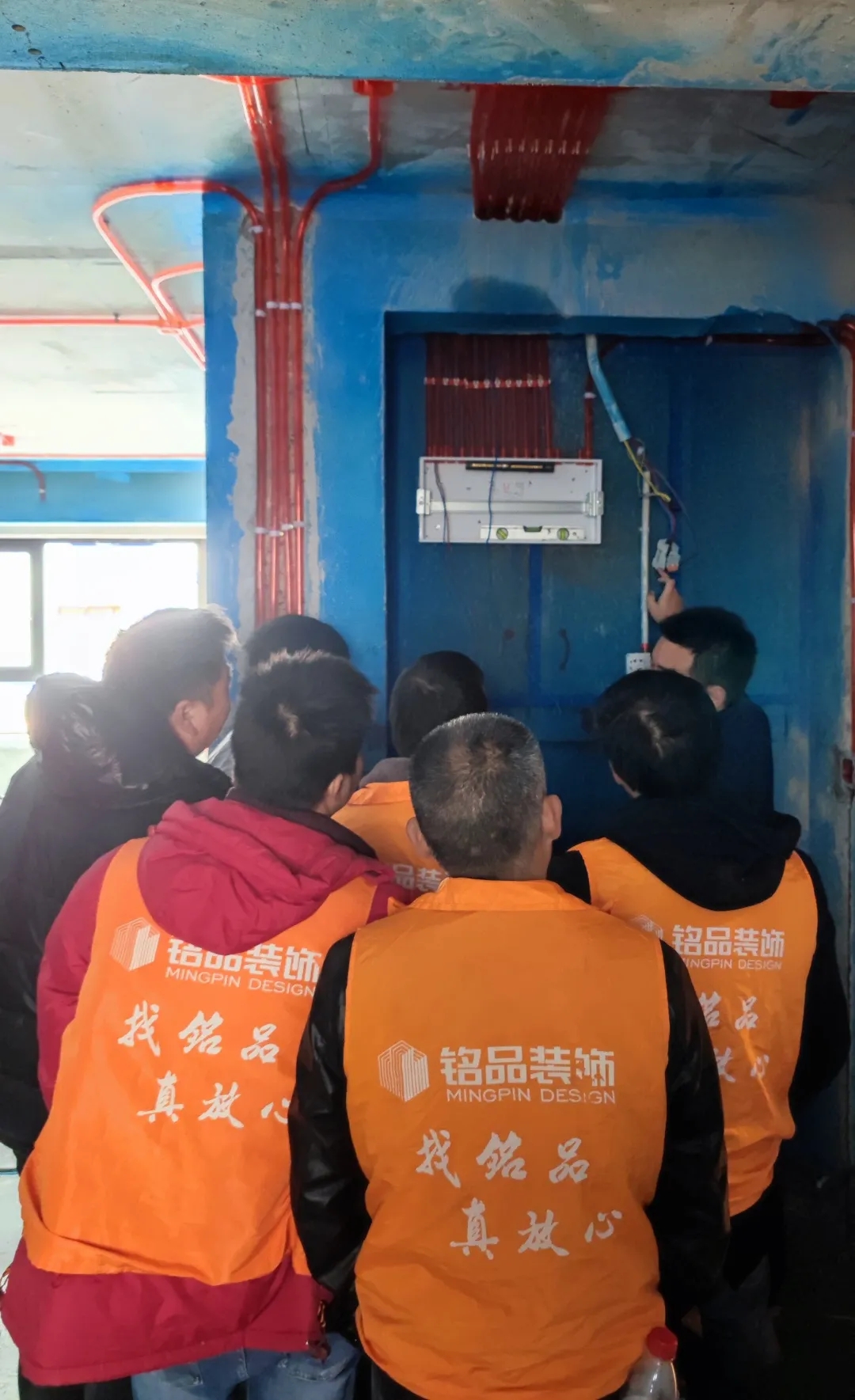 王經(jīng)理檢查配電箱并講解安全用電知識。